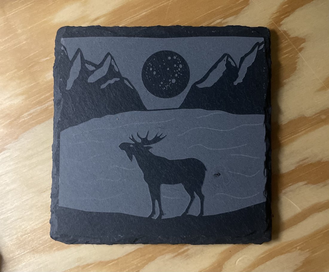 Engraved slate coaster with a mountain and elk scene